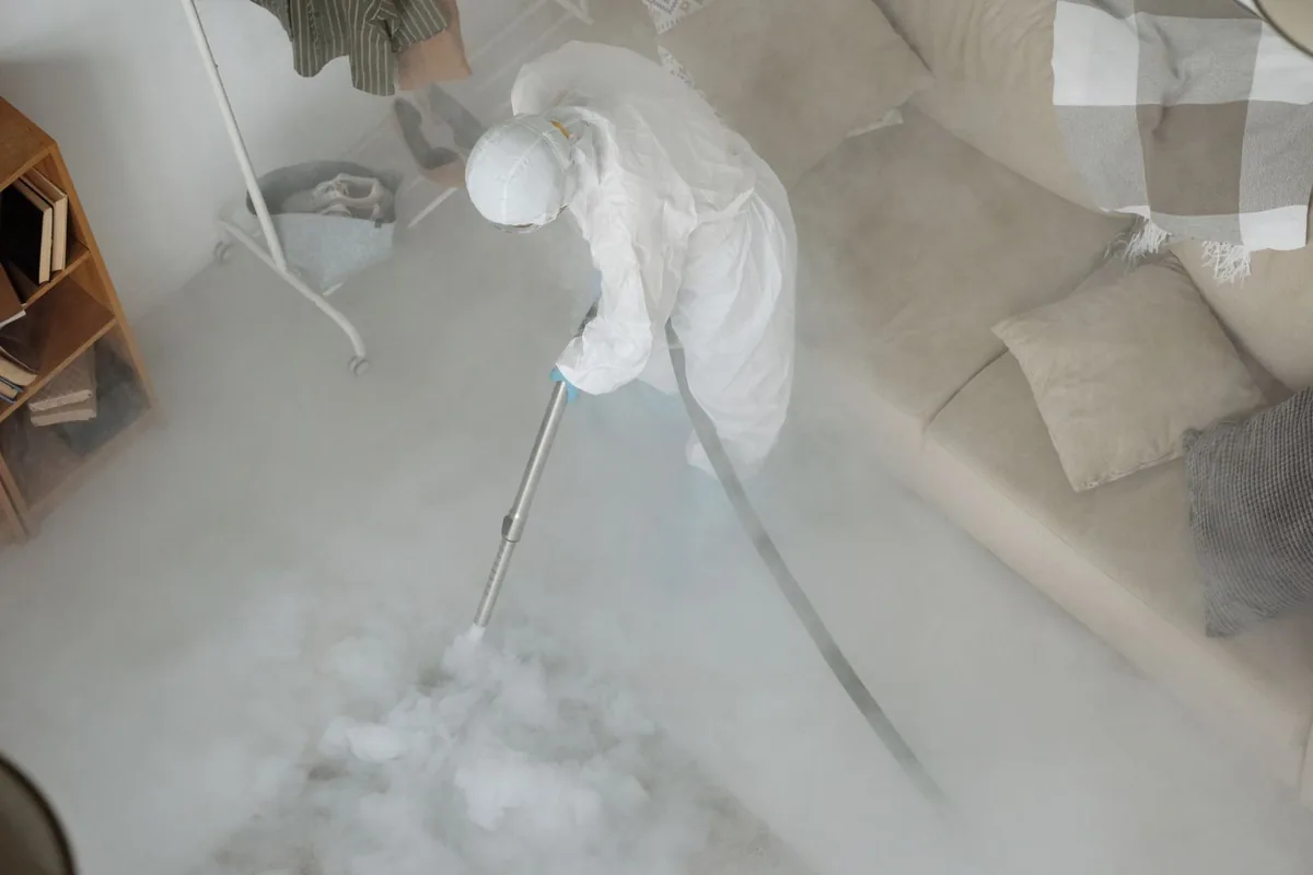 Biohazard cleanup technician in protective equipment, Larned, KS